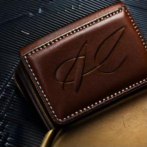 A full-grain leather wallet showing natural character